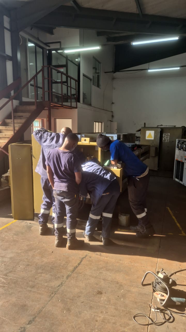 Technicians working on the LV compartment of a TNA mini-substation
